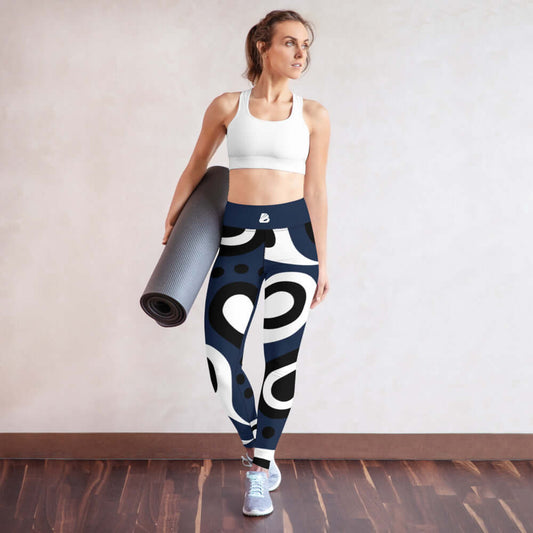 Woman wearing Yoga-Leggings N°31 with abstract pattern, holding yoga mat, showcasing four-way stretch and comfort in workout attire.