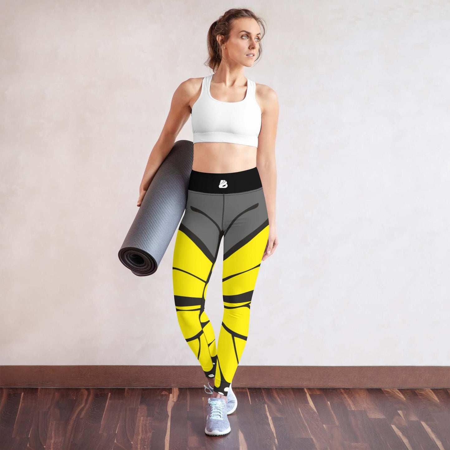 Woman wearing Yoga-Leggings N°41 holding a yoga mat in a studio setting.