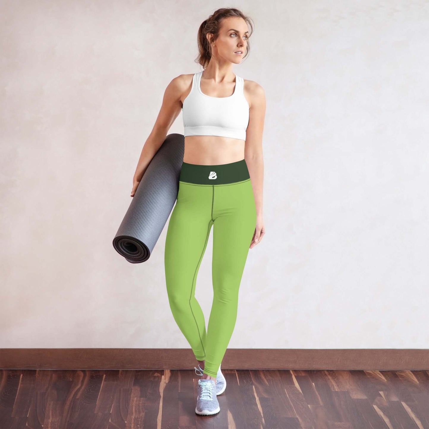 Yoga-Leggings N°43 in bright green worn by a woman holding a yoga mat, showcasing the stretch and comfort of the leggings.
