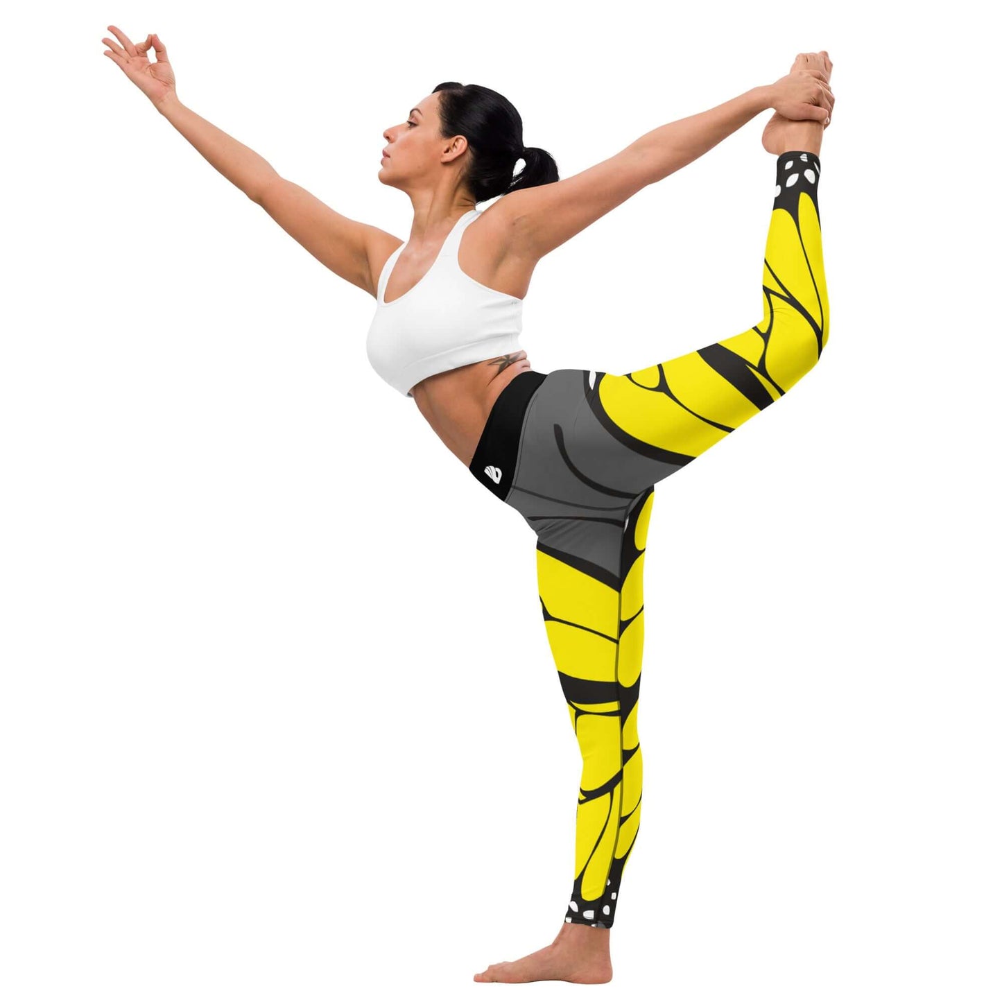 Woman practicing yoga in Yoga-Leggings N°41 with yellow and black design, performing a stretch pose, demonstrating flexibility and comfort.