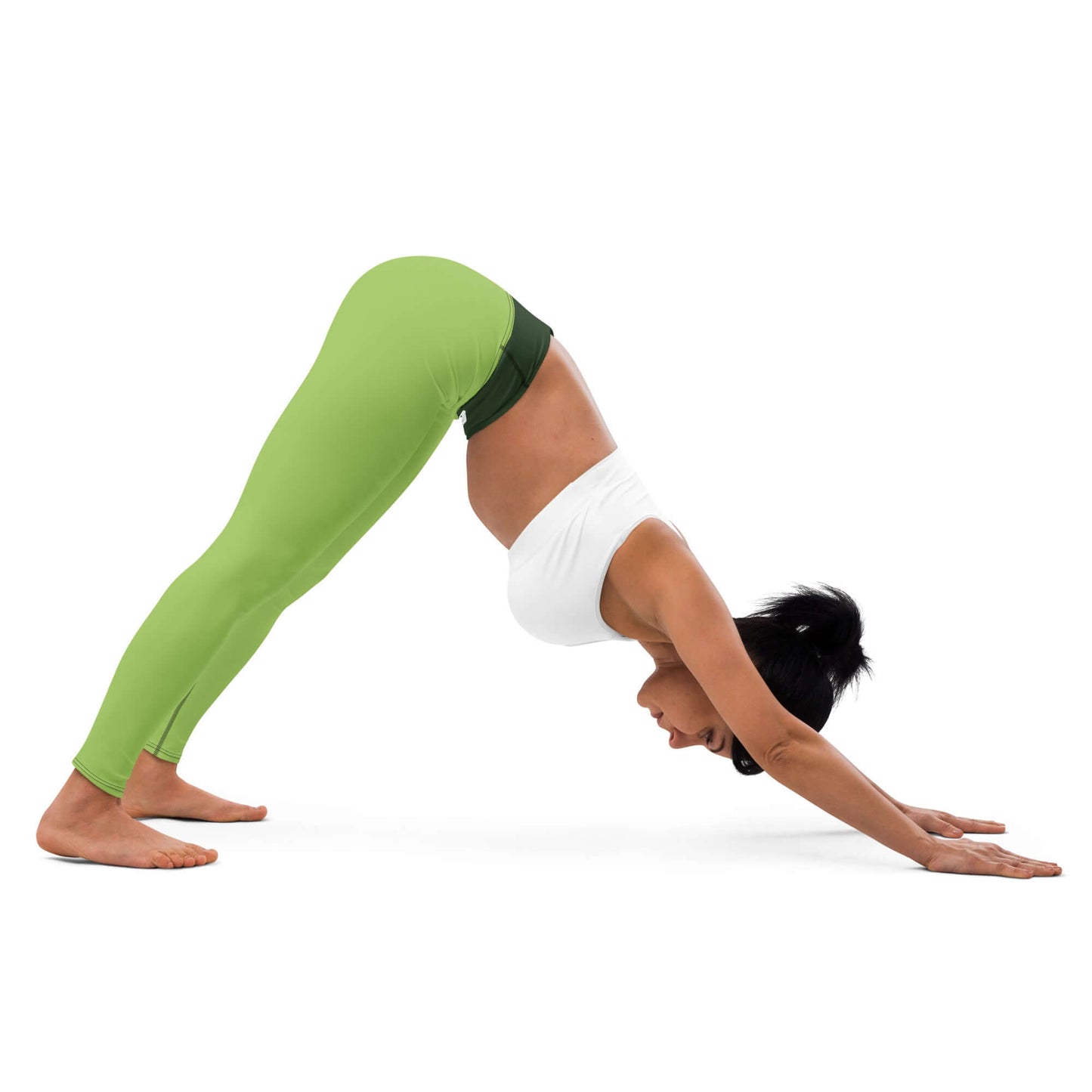 Woman practicing yoga in green Yoga-Leggings N°43, demonstrating downward dog pose.