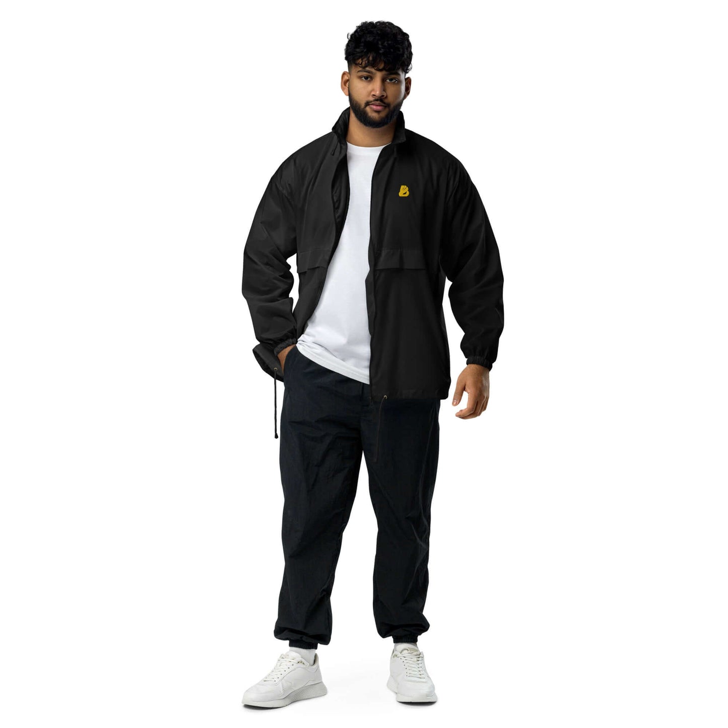 Man wearing Basic-Unisex-Windbreaker N°0 in black, showcasing durable, water-repellent design with zip closure and elastic cuffs.