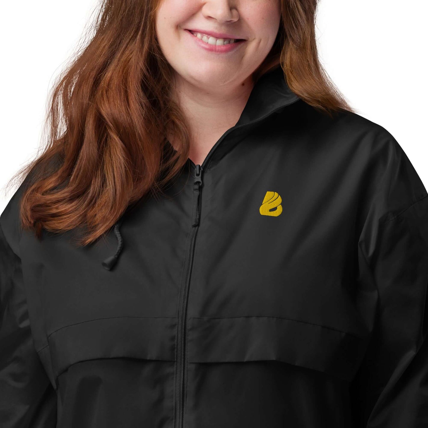 Woman wearing Basic-Unisex-Windbreaker N°0 in black, highlighting zipper and logo