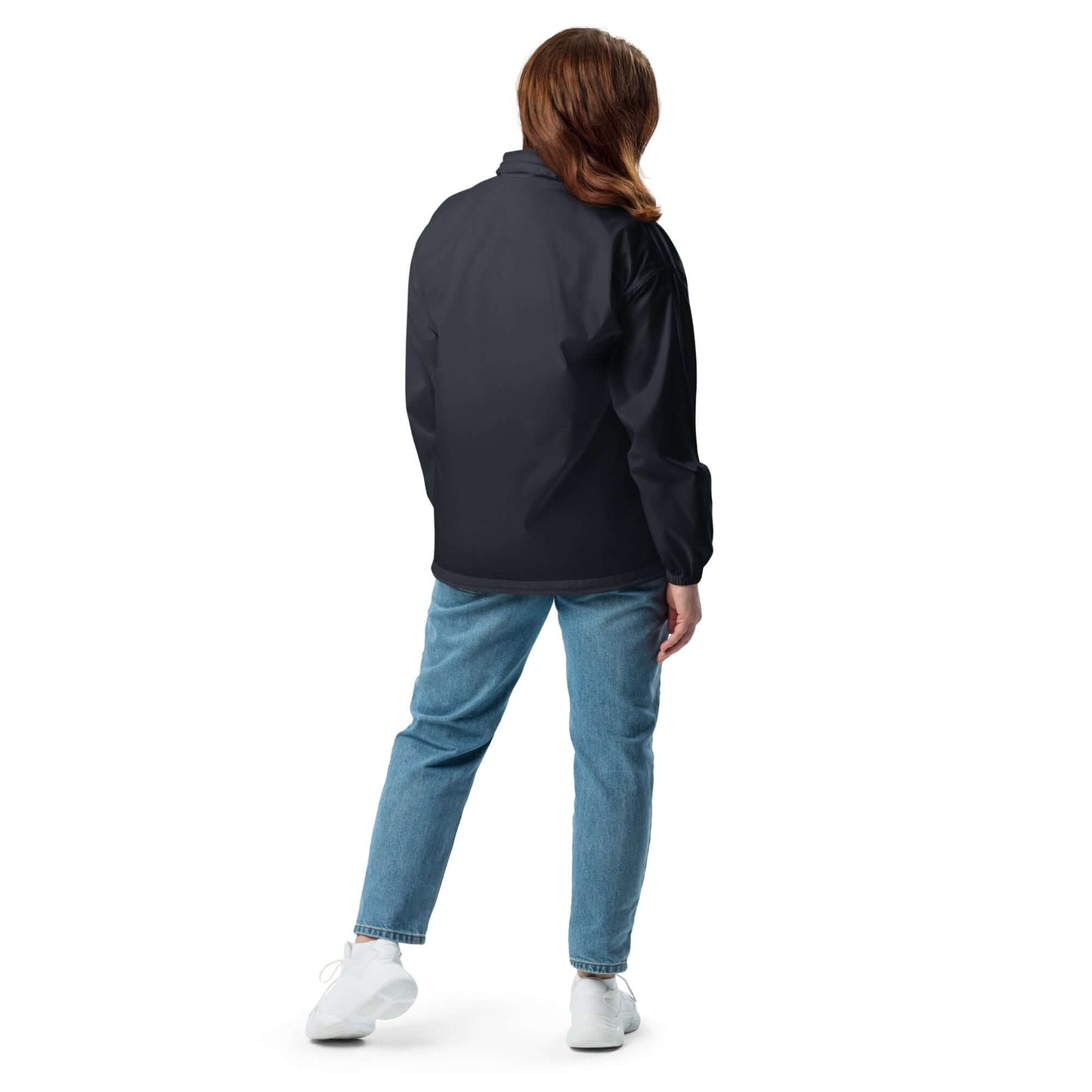 Person wearing Basic-Unisex-Windbreaker N°0, showing back view in casual outfit with jeans and sneakers, illustrating lightweight design.