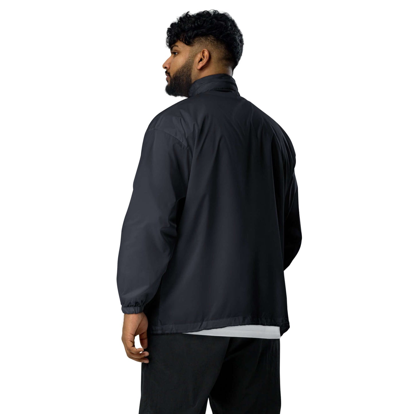 Alt Tag: Man wearing Basic-Unisex-Windbreaker N°0 in black, demonstrating the lightweight, water-repellent design with elastic cuffs.