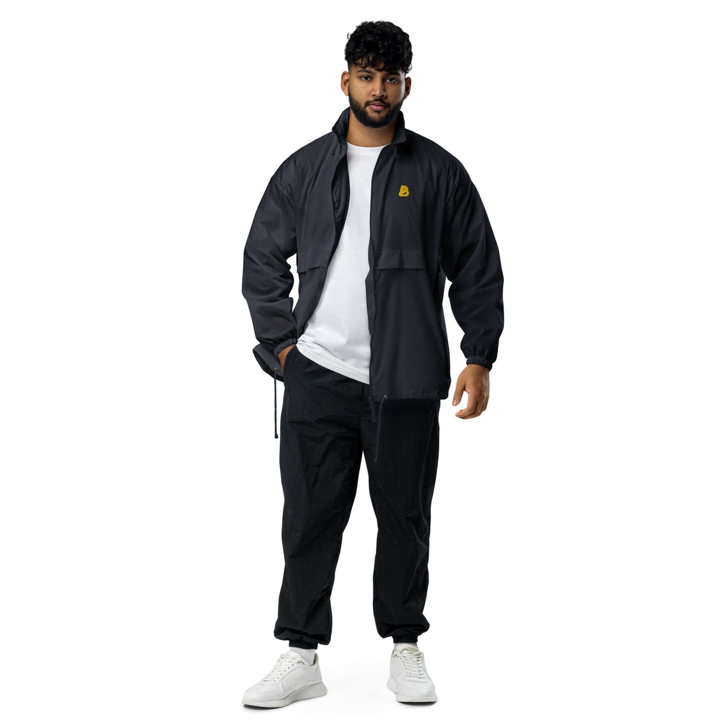Man wearing Basic-Unisex-Windbreaker N°0 in black, showcasing sporty and casual design for outdoor activities like hiking and errands.