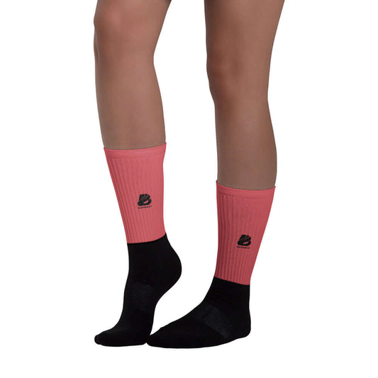 Person wearing Socken N°0 with black soles and vibrant colored ribbed leggings, highlighting comfort and style.