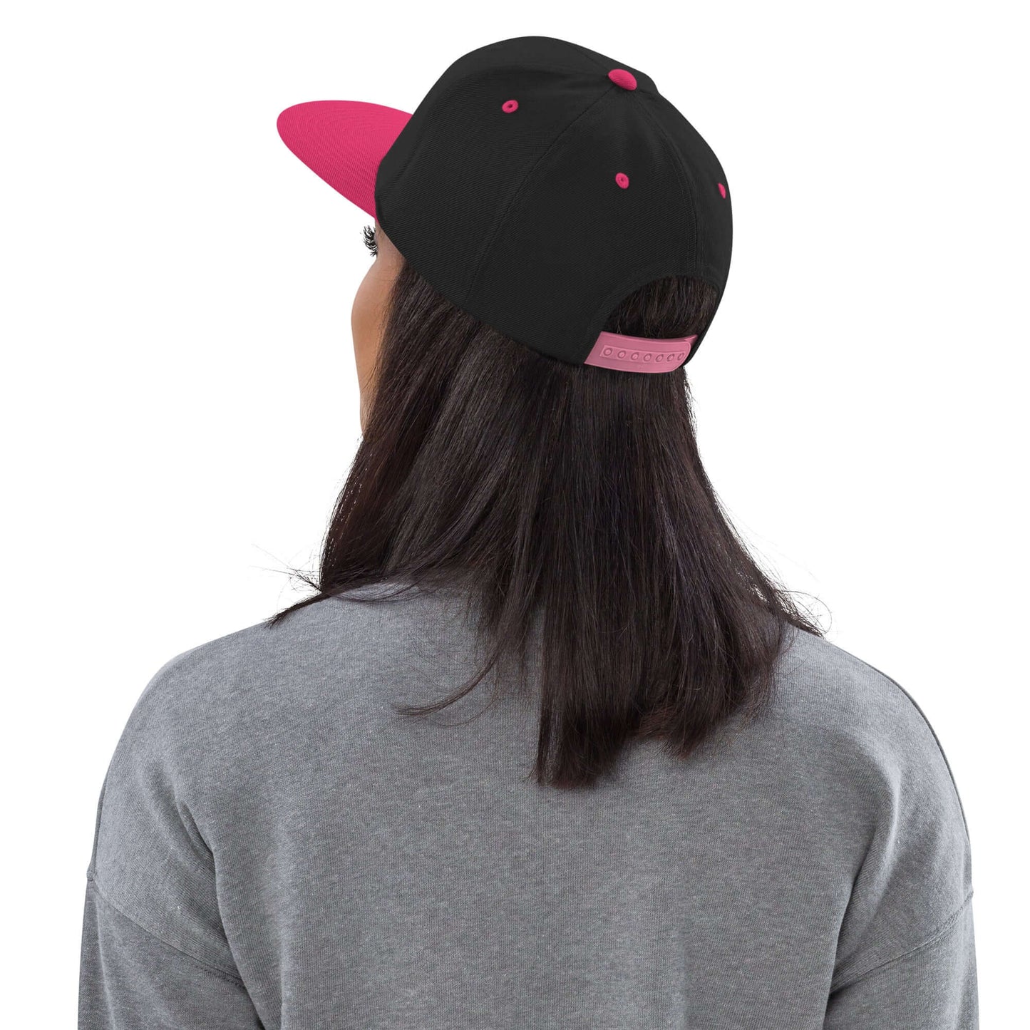 Rear view of person wearing Snapback-Cap N°6 with pink brim, featuring adjustable snap closure and classic fit.