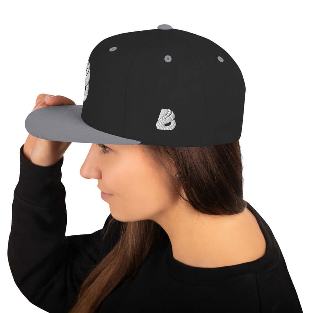 Woman wearing Snapback-Cap N°1 with classic fit and flat brim, showcasing design and style.