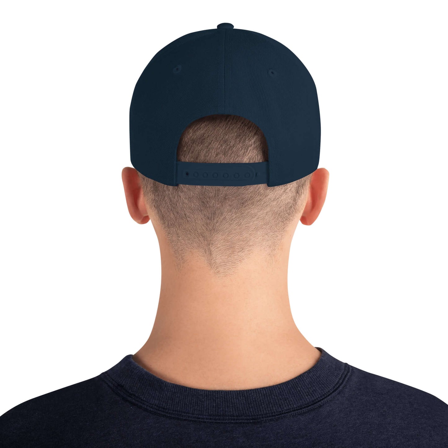 Back view of Snapback-Cap N°5 with adjustable snap closure and structured design on a person wearing a navy cap.