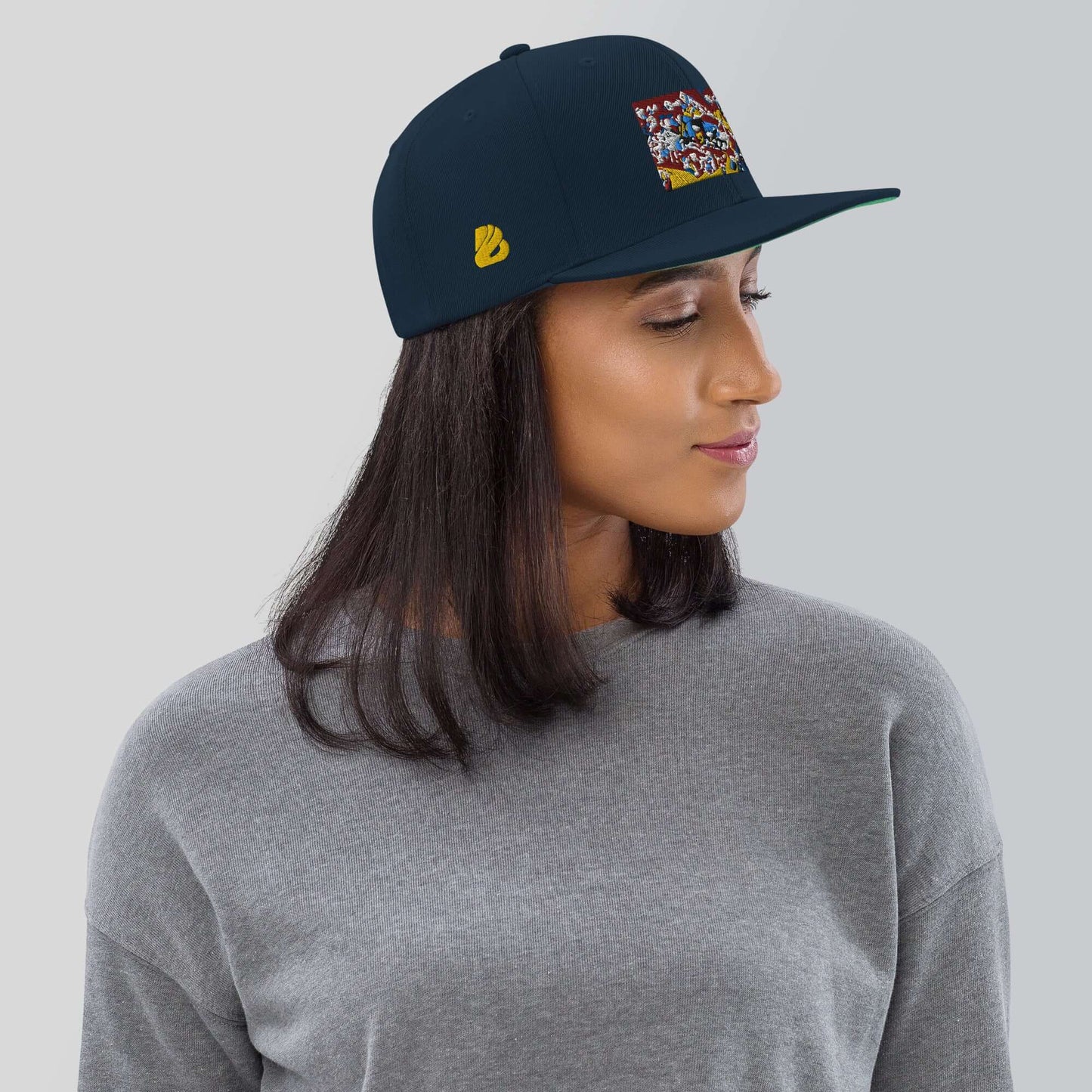 Woman wearing Snapback-Cap N°4 with classic fit, flat bill, and snap closure, featuring a colorful patch design.