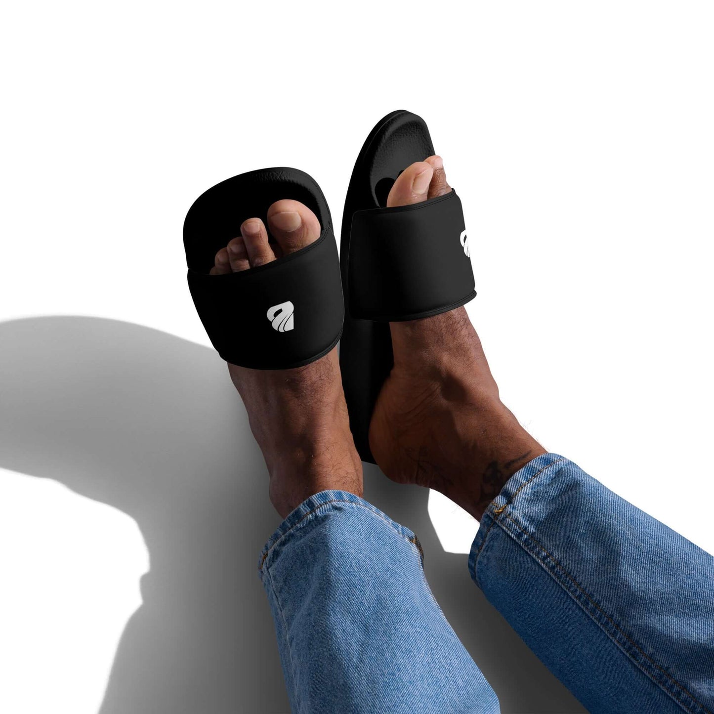 Person wearing Herren-Schlappen N°1 with padded straps and textured footbed, showcasing comfort and style for summer activities.