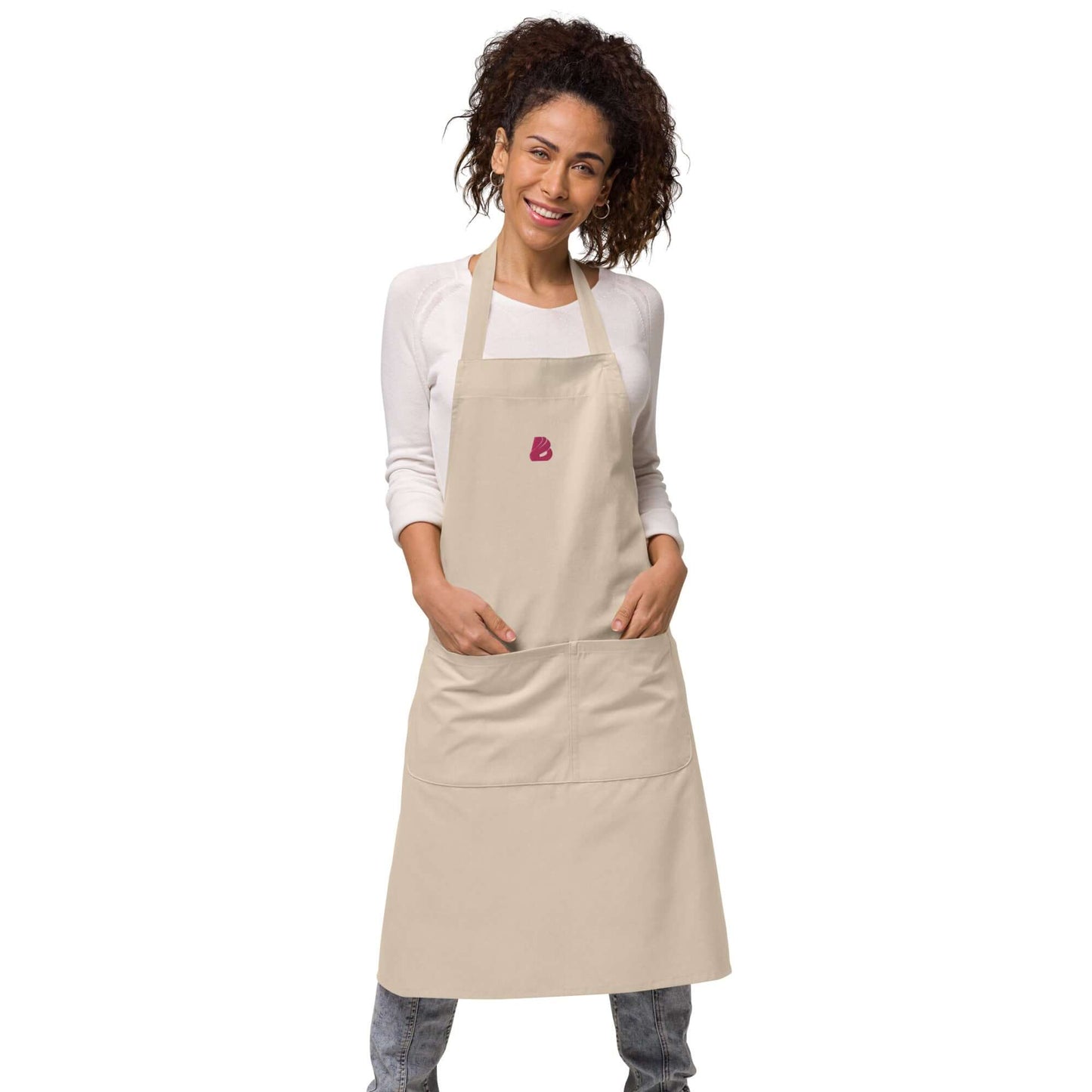 Person wearing Schürze aus Bio-Baumwolle N°0 with adjustable straps and front pocket, offering kitchen protection and style, made from organic cotton.
