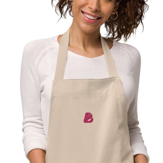 Schürze aus Bio-Baumwolle N°0 worn by person, featuring adjustable straps and front pocket, eco-friendly kitchen attire