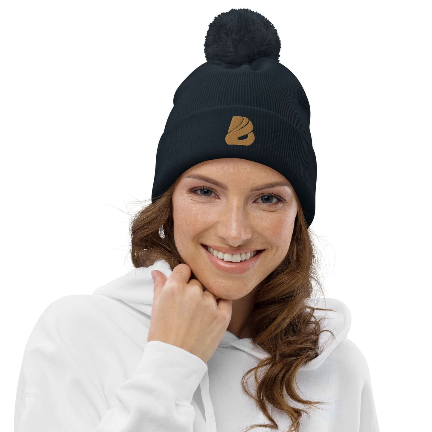 Woman wearing Bommel-Beanie N°0, soft acrylic pompom hat, ideal for autumn and winter warmth.