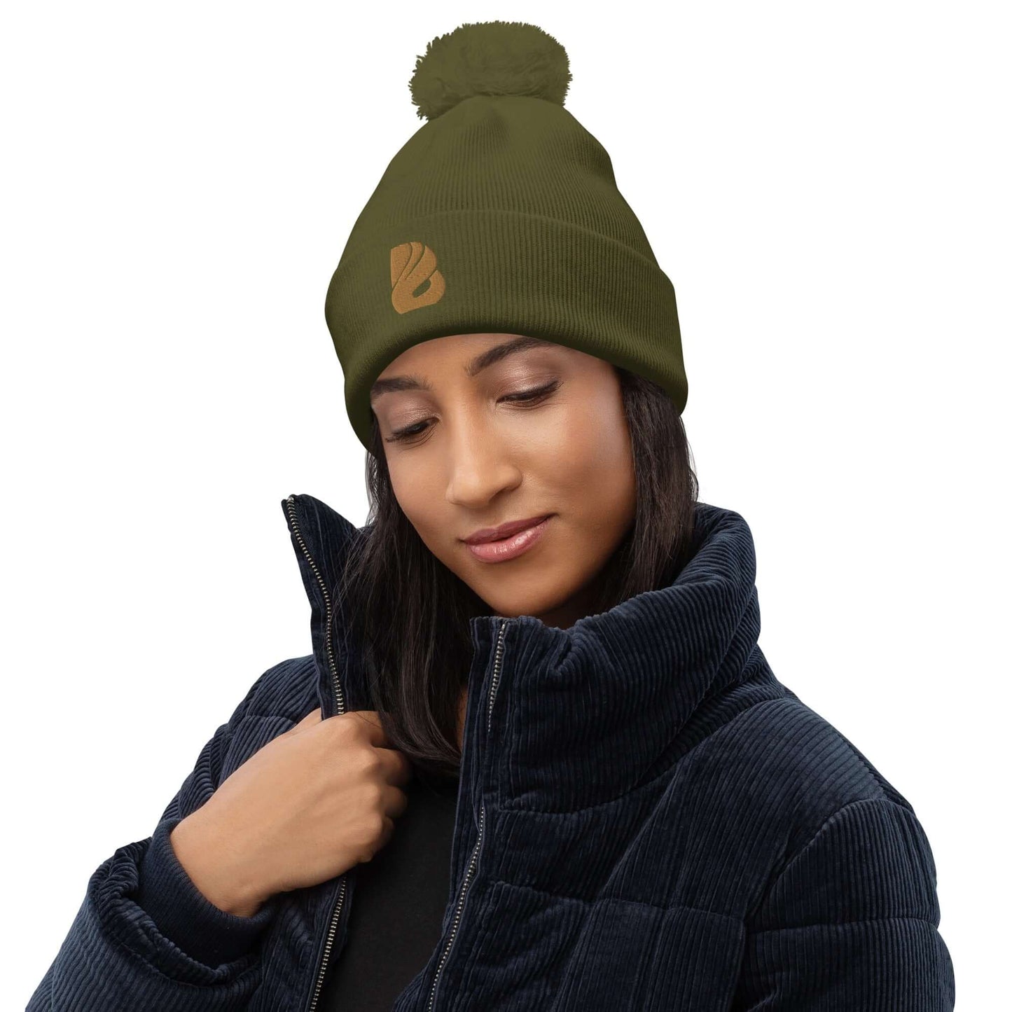 Woman wearing Bommel-Beanie N°0, an olive green pom-pom hat made from 100% soft acrylic fiber, perfect for cozy autumn and winter days.