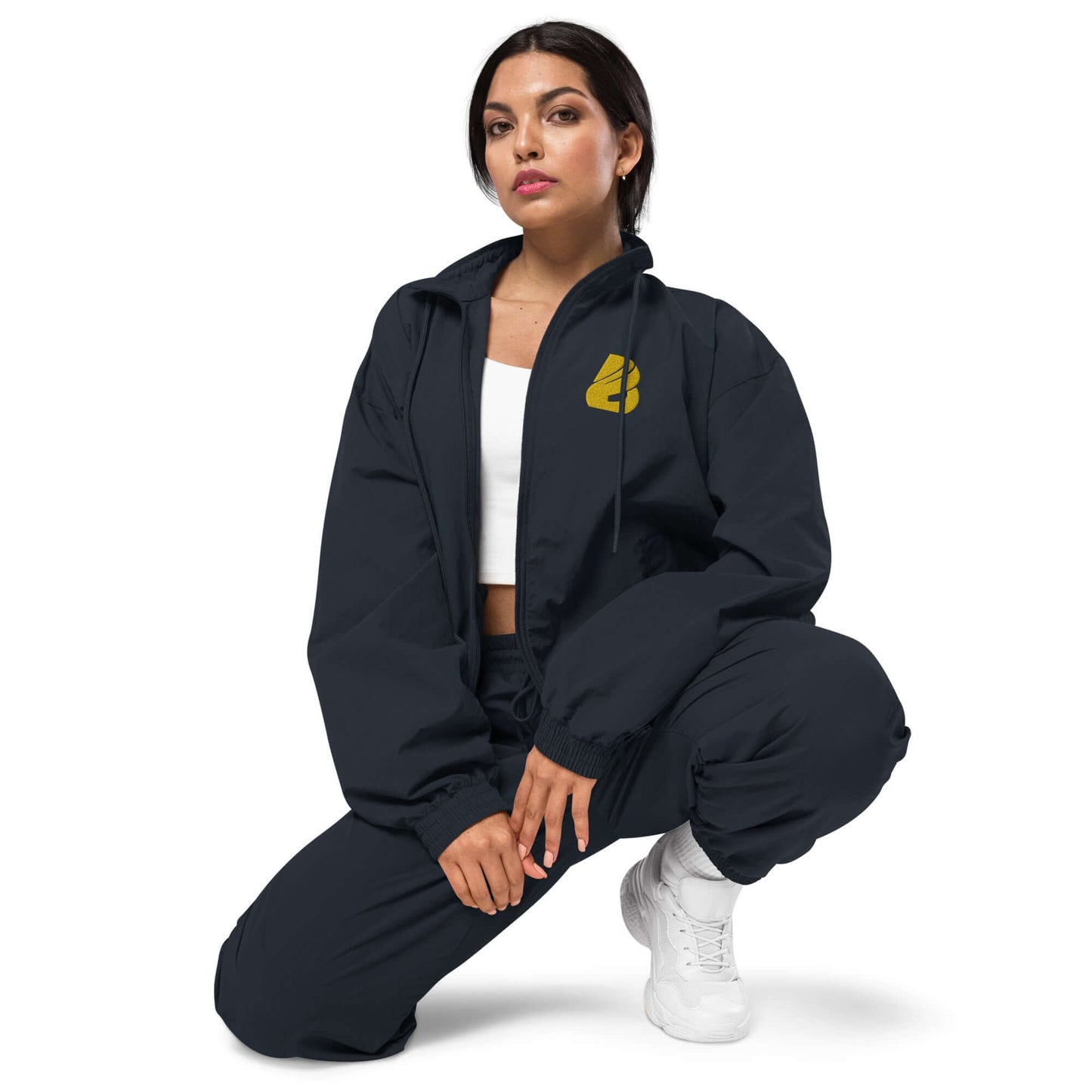Woman wearing Recyclete Trainingsjacke N°1, a versatile black jacket ideal for stylish and formal outfits, paired with matching pants.