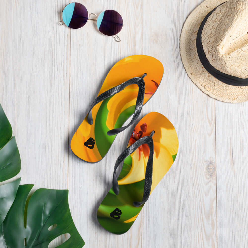 Colorful Flip-Flops N°5 with black straps and tropical print on wooden floor, perfect for summer adventures.