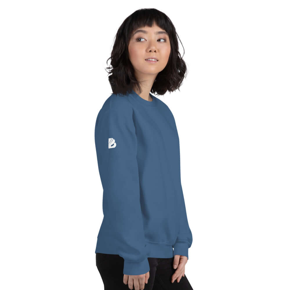 Woman wearing Unisex-Pullover N°5, blue color, showcasing classic fit and soft feel with ribbed collar, perfect for cold seasons.