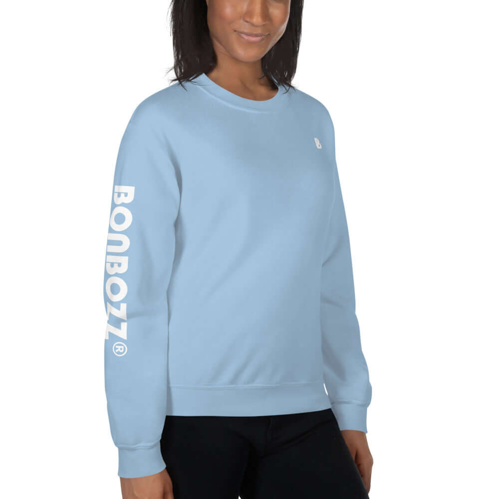 Woman wearing Unisex-Pullover N°13, light blue, long sleeve, and Bonbozz logo, showcasing a cozy, warm design perfect for cold weather.