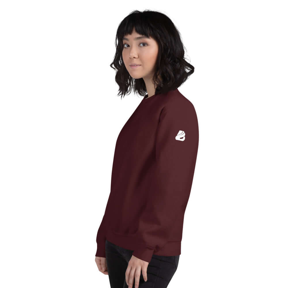Model wearing maroon Unisex-Pullover N°5 showcasing its classic cut and soft texture with logo on sleeve.