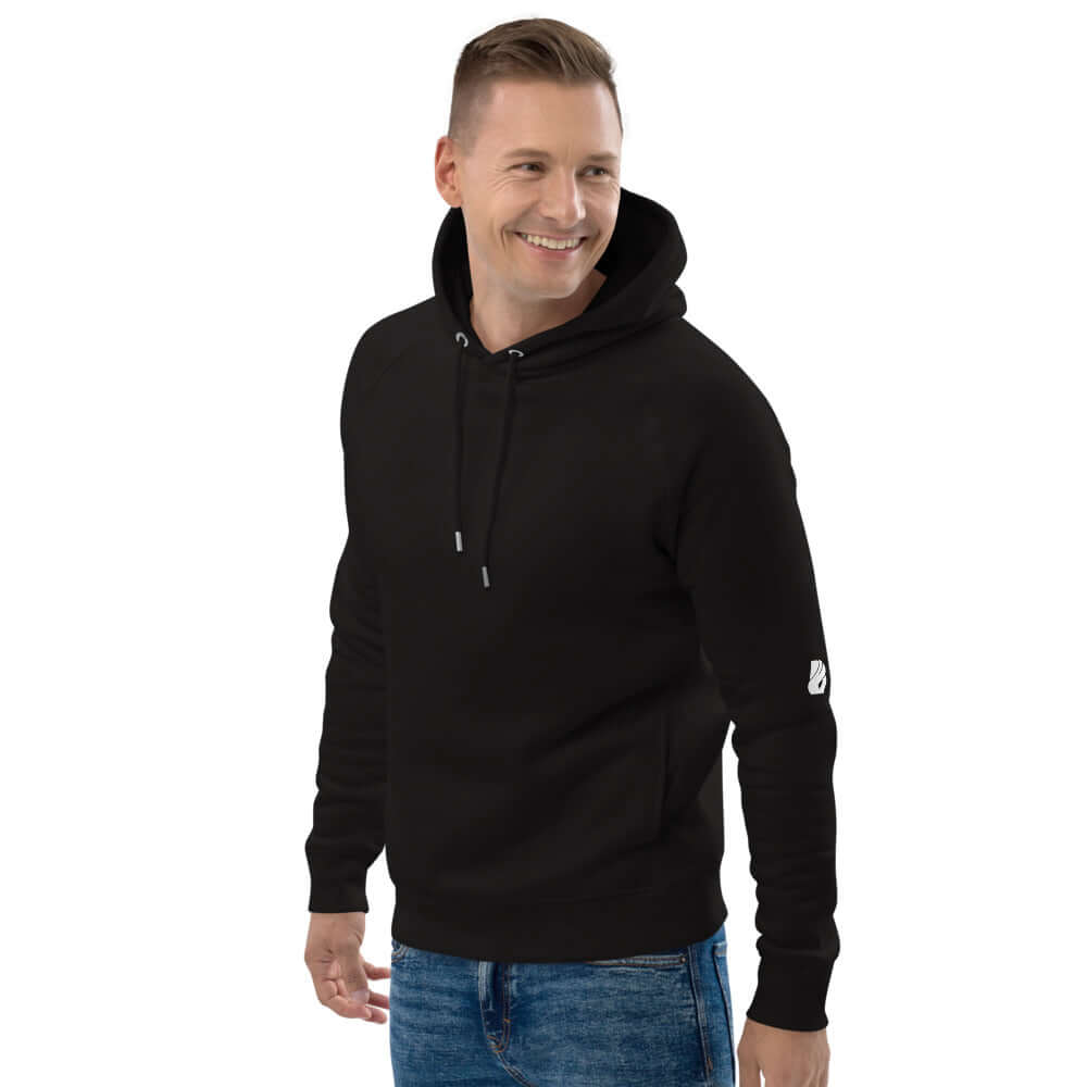 Man wearing Unisex Kapuzenpullover N°35 in black, made from organic cotton and recycled polyester, featuring practical side pockets.