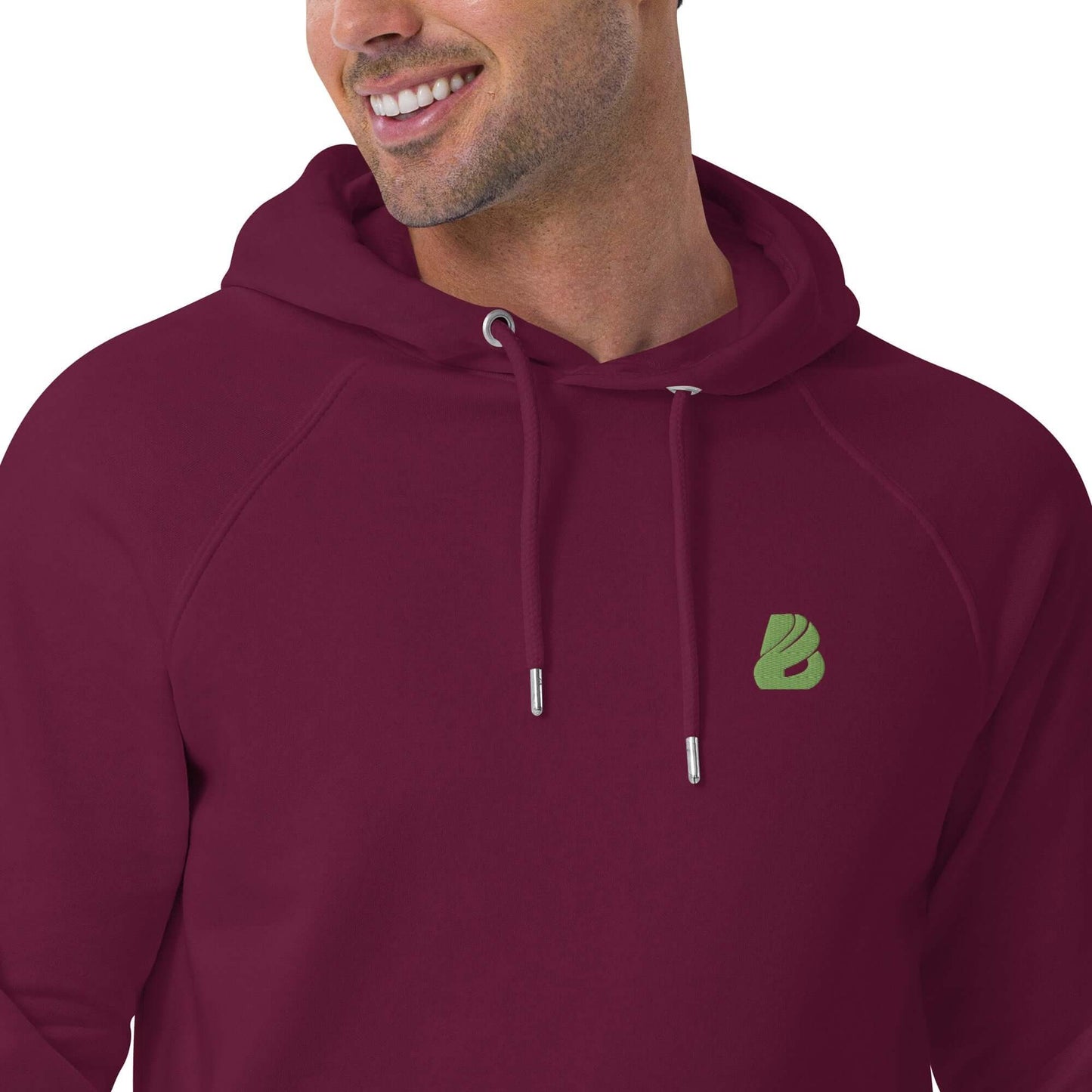 Man wearing Unisex Bio-Raglan-Hoodie N°0 in burgundy, showcasing comfortable and stylish fashion with a soft interior.