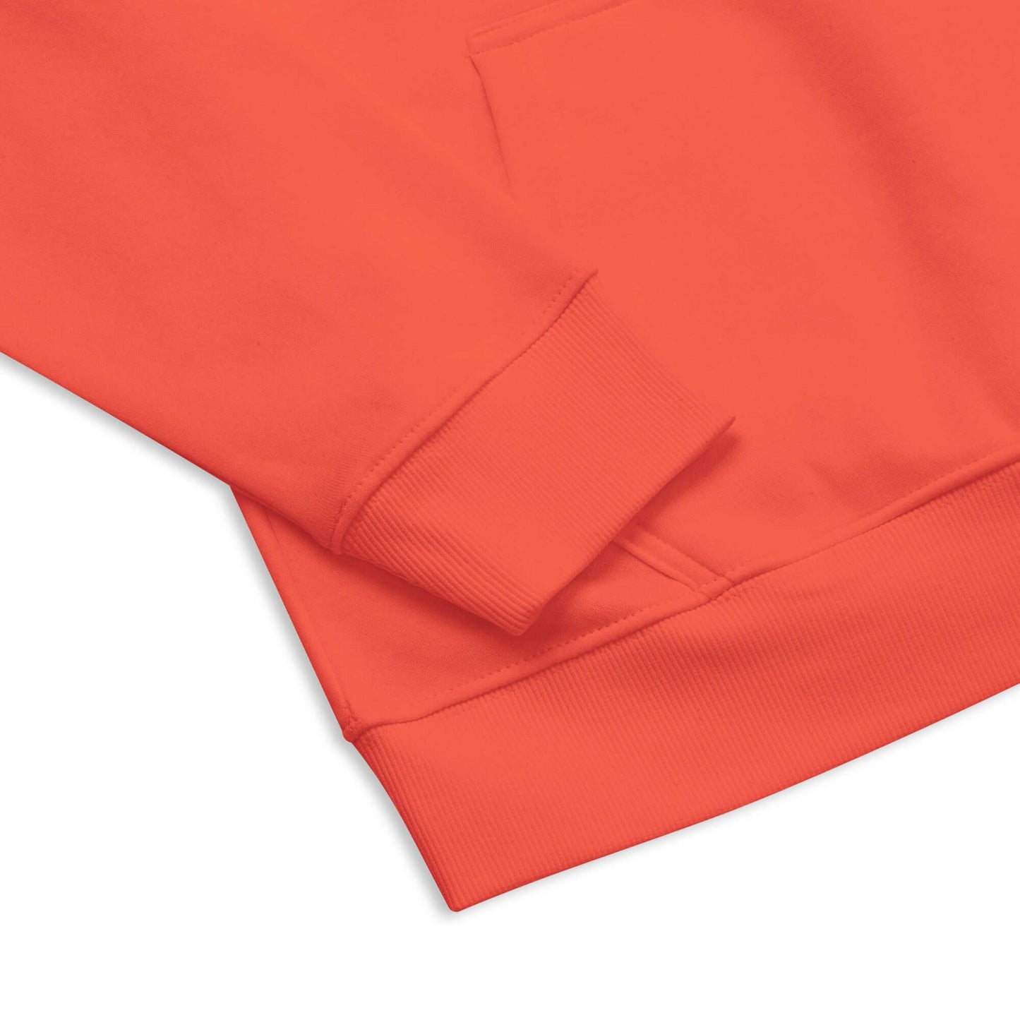 Close-up of red Unisex Bio-Raglan-Hoodie N°1 sleeve and pocket detail highlighting soft, comfortable fabric.