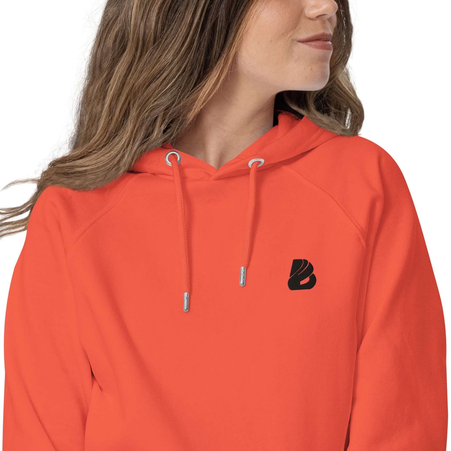 Woman wearing Unisex Bio-Raglan-Hoodie N°1 in orange with relaxed fit and comfort-focused design