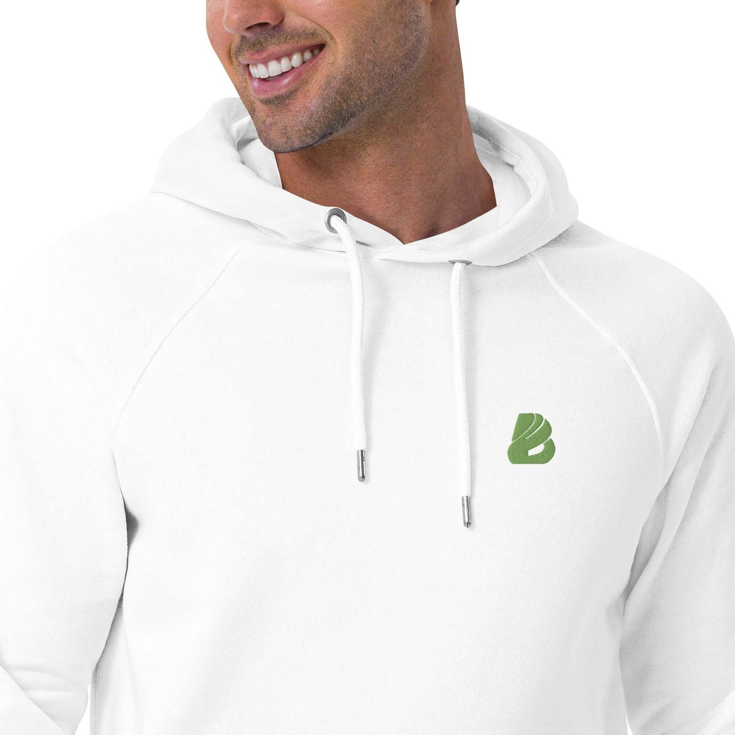 Person wearing a white Unisex Bio-Raglan-Hoodie N°0 with green logo, smiling and looking to the side.