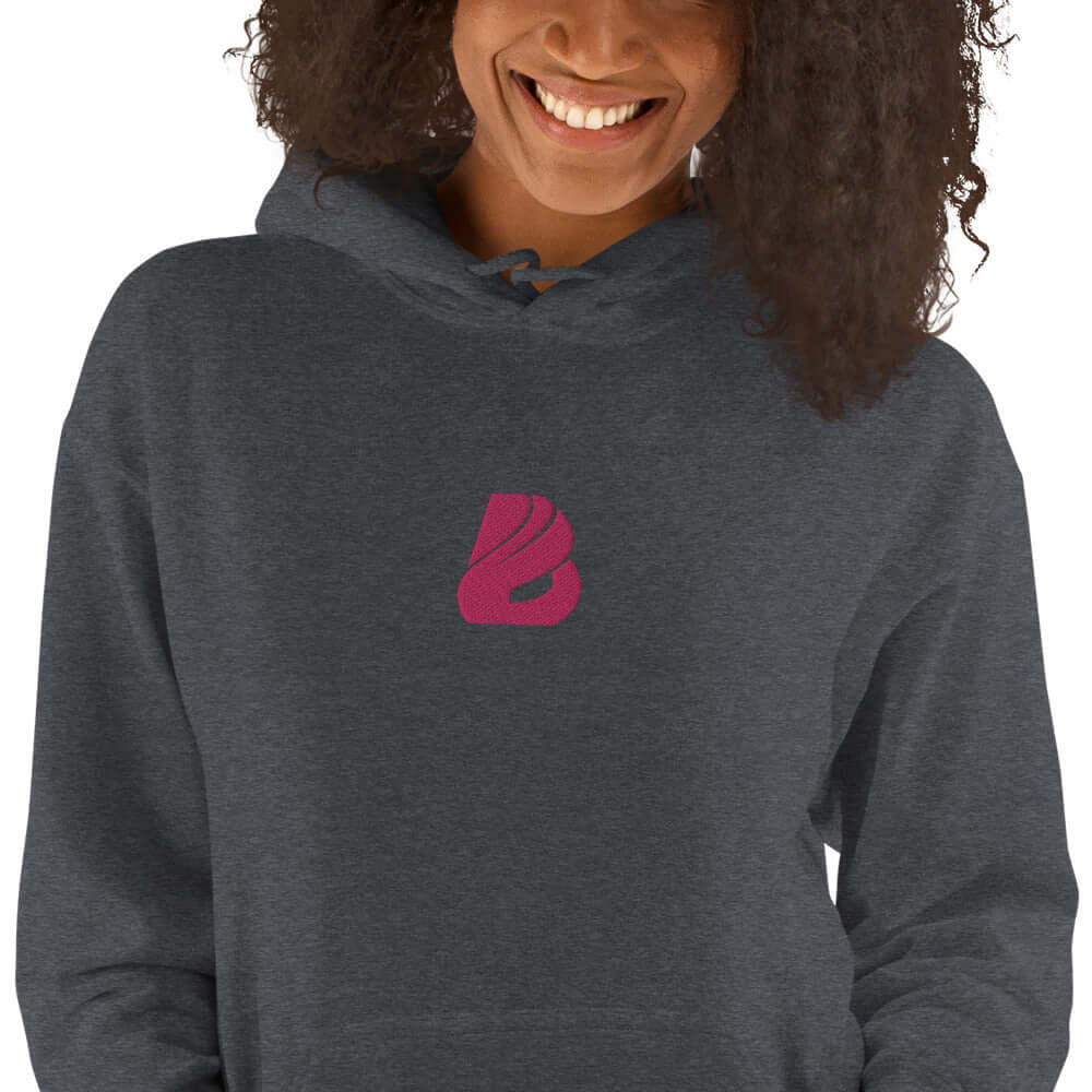 Unisex-Kapuzenpullover N°44 in dark grey with unique pink logo, perfect for cozy evenings, featuring soft cotton-poly blend fabric.