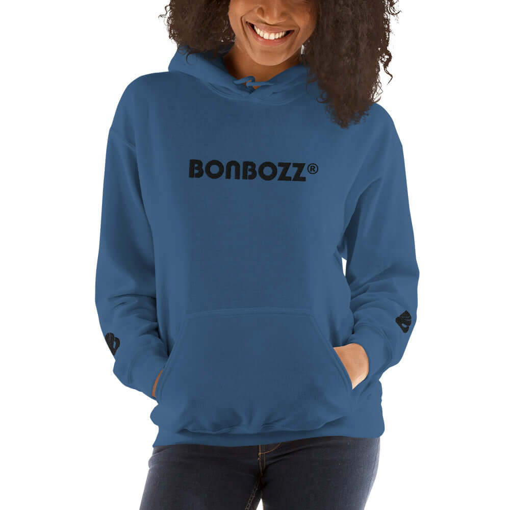 Woman wearing blue Unisex-Kapuzenpullover N°46 with Bonbozz logo, showcasing comfort and style for cool evenings.