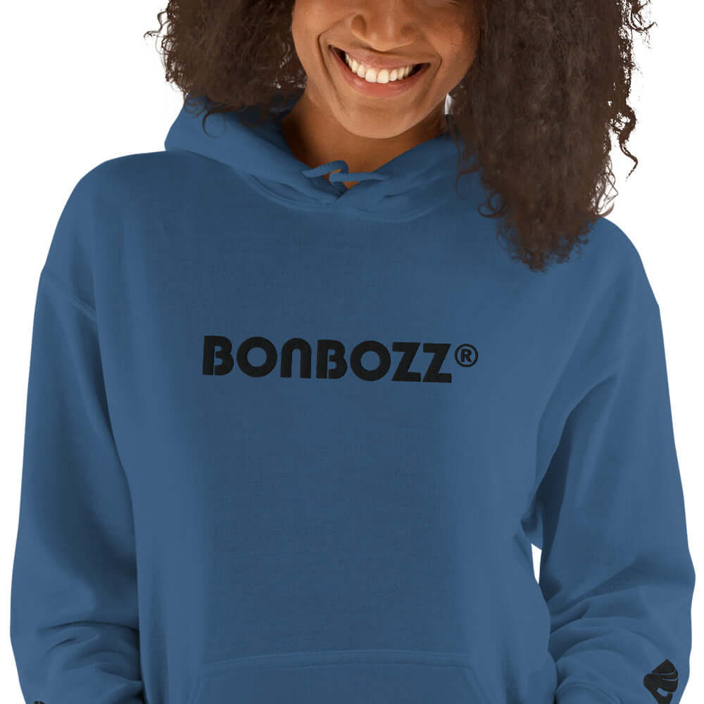 Person wearing Unisex-Kapuzenpullover N°46 in blue showing BONBOZZ logo, soft and stylish choice for cool weather.