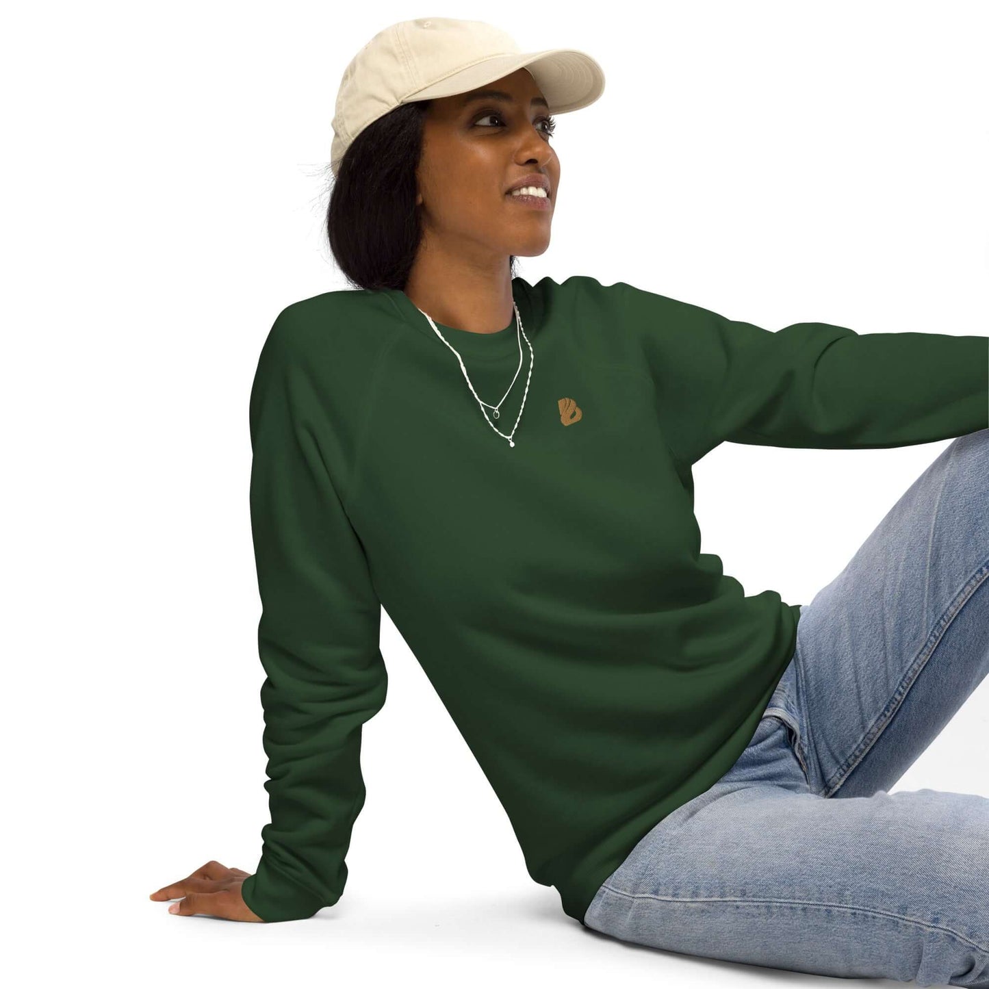 Person wearing Unisex Bio-Raglan-Pullover N°0, a stylish dark green sweatshirt with jeans, showcasing comfort and eco-friendly fashion.