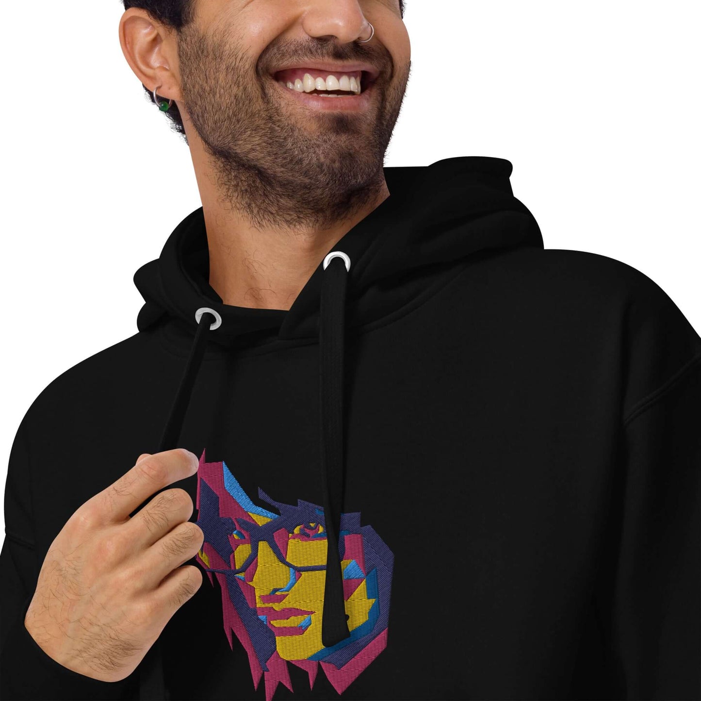 Man wearing Unisex-Kapuzenpullover N°39 with colorful graphic design, showcasing hood and kangaroo pocket, made of cotton blend for cool evenings.