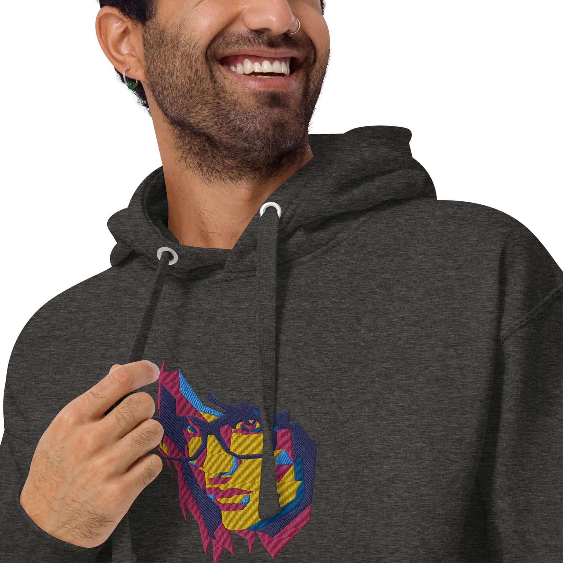 Man wearing Unisex-Kapuzenpullover N°39 with vibrant graphic design, featuring kangaroo pocket and warm hood for cool evenings.