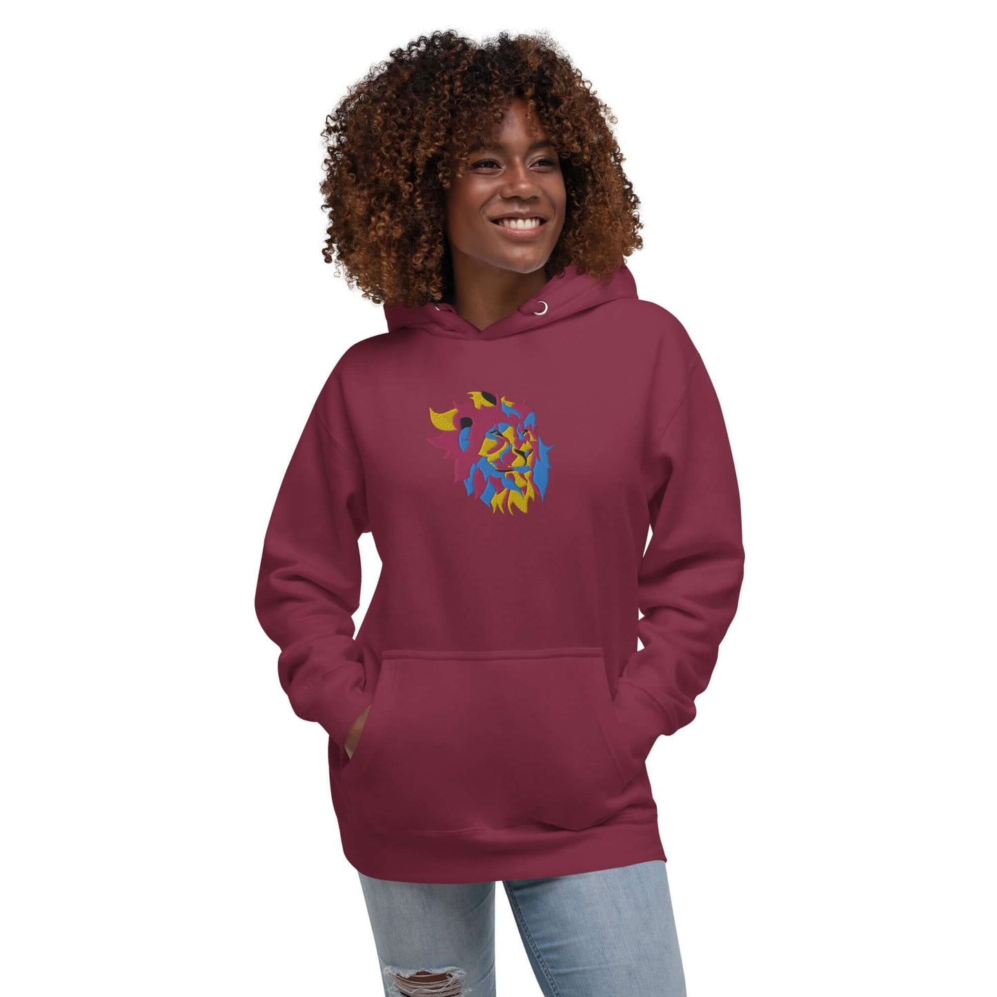 Woman wearing Unisex-Kapuzenpullover N°40 in red with colorful design, features soft cotton blend, kangaroo pocket, and hood.