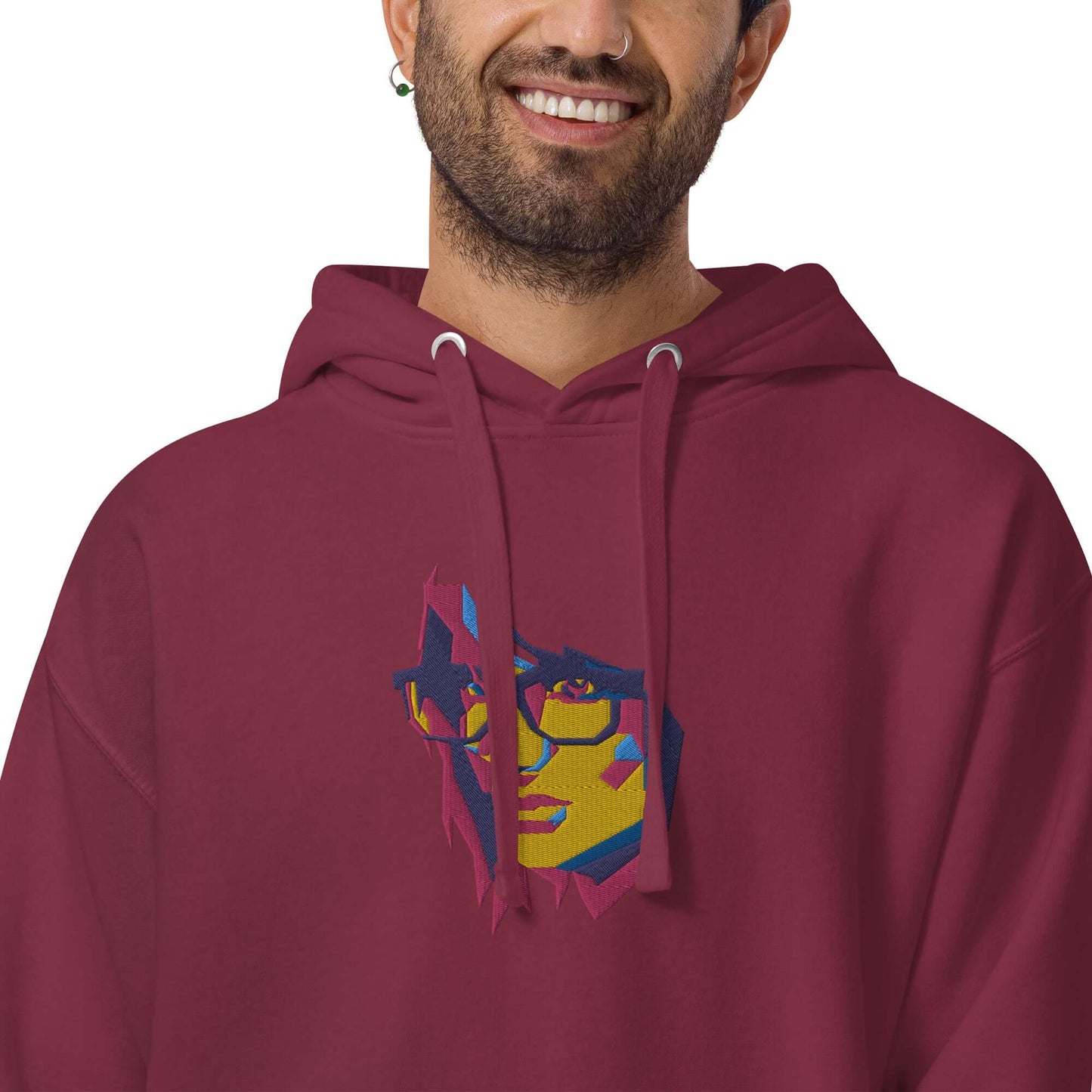 Unisex-Kapuzenpullover N°39 in burgundy with a colorful abstract face design, featuring a comfy hood and kangaroo pocket.