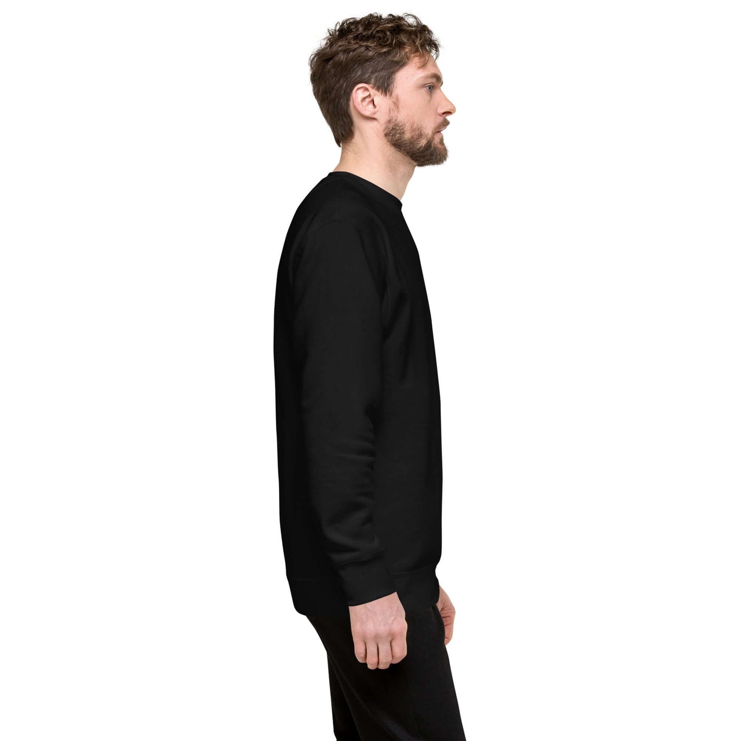 Side view of man wearing Unisex-Premium-Pullover N°0, black, classic style with ribbed crew neck and cuffs, soft fleece interior.