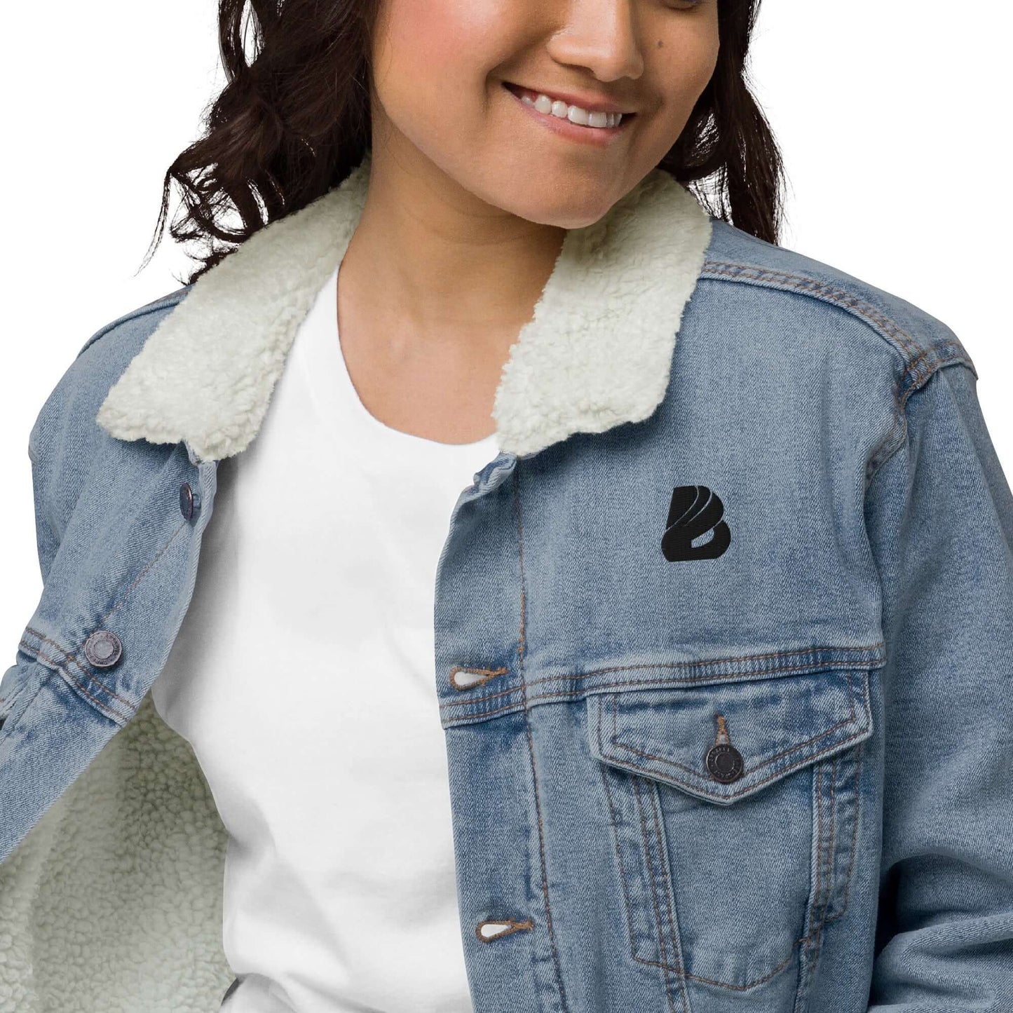 Unisex Sherpa Jeansjacke N°2 in denim with warm sherpa lining, modeled by a person wearing a white shirt, sustainable fashion.