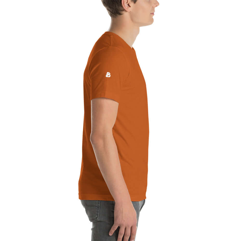 Side view of orange Unisex-T-Shirt N°0 showcasing soft, lightweight, and stretchy material on model.