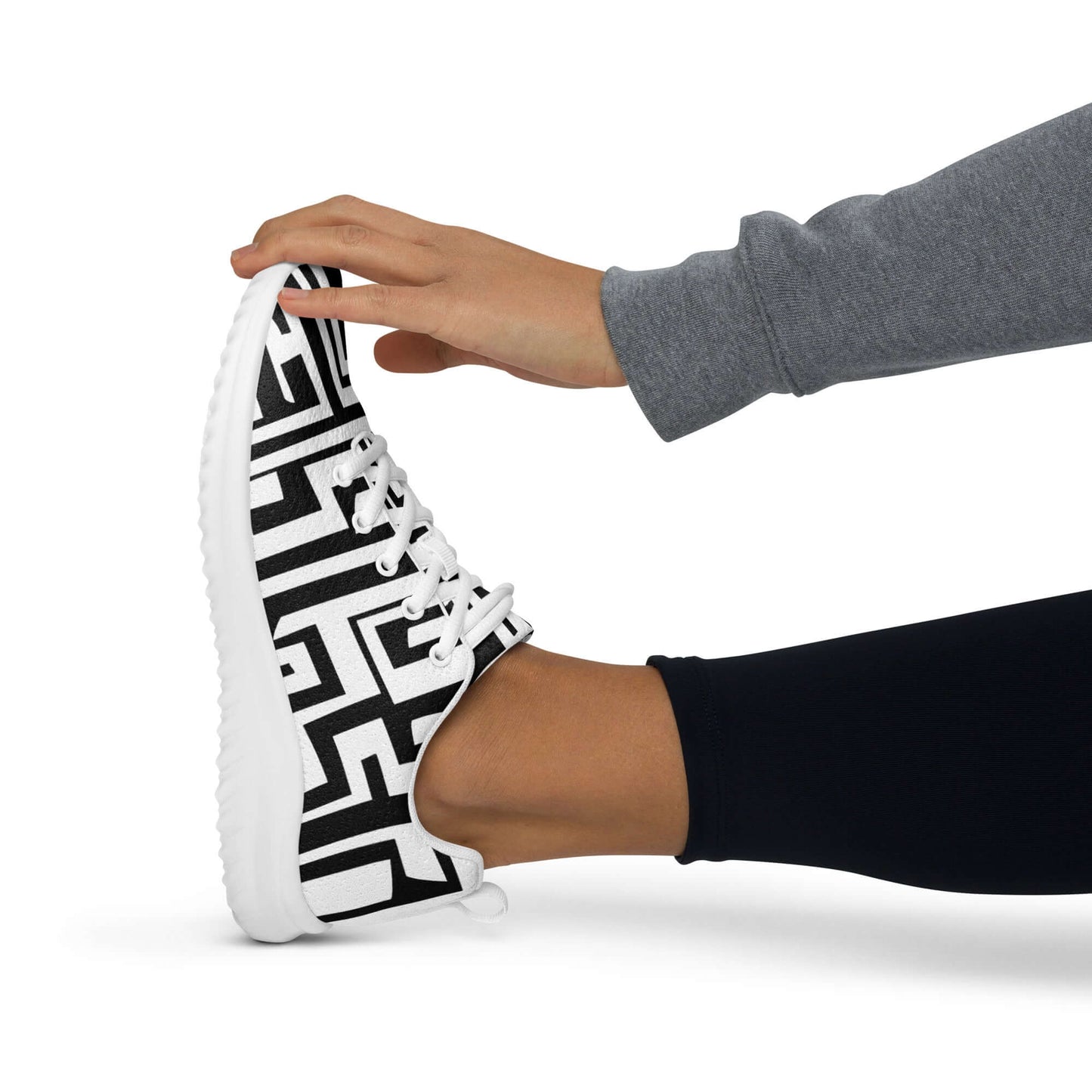 Person stretching while wearing Damen-Turnschuhe N°1 with geometric design, showcasing comfort and flexibility.