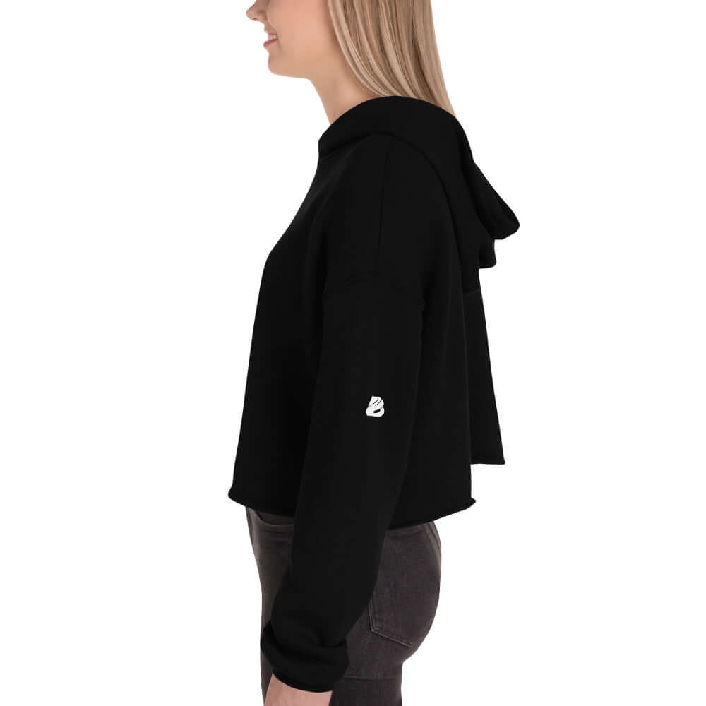 Woman wearing black Crop-Hoodie N°0 with raw hem and matching drawstring, side view.