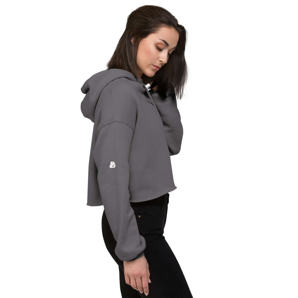 Woman wearing Crop-Hoodie N°0 in gray with raw hem and matching drawstring, showcasing trendy, cut-off design.