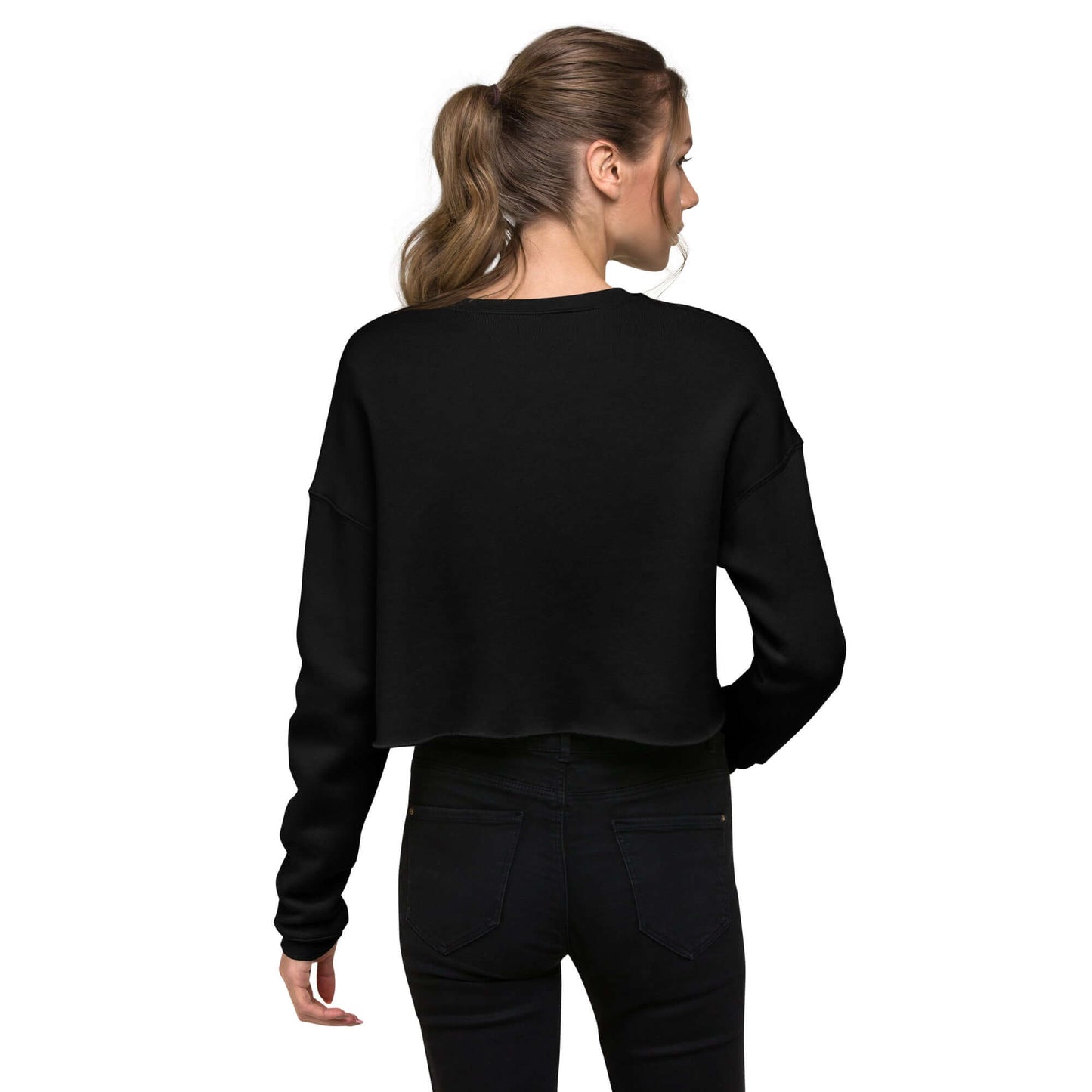 Back view of woman wearing the Crop-Pullover N°0 in black, showcasing ribbed neckline and raw hem style.