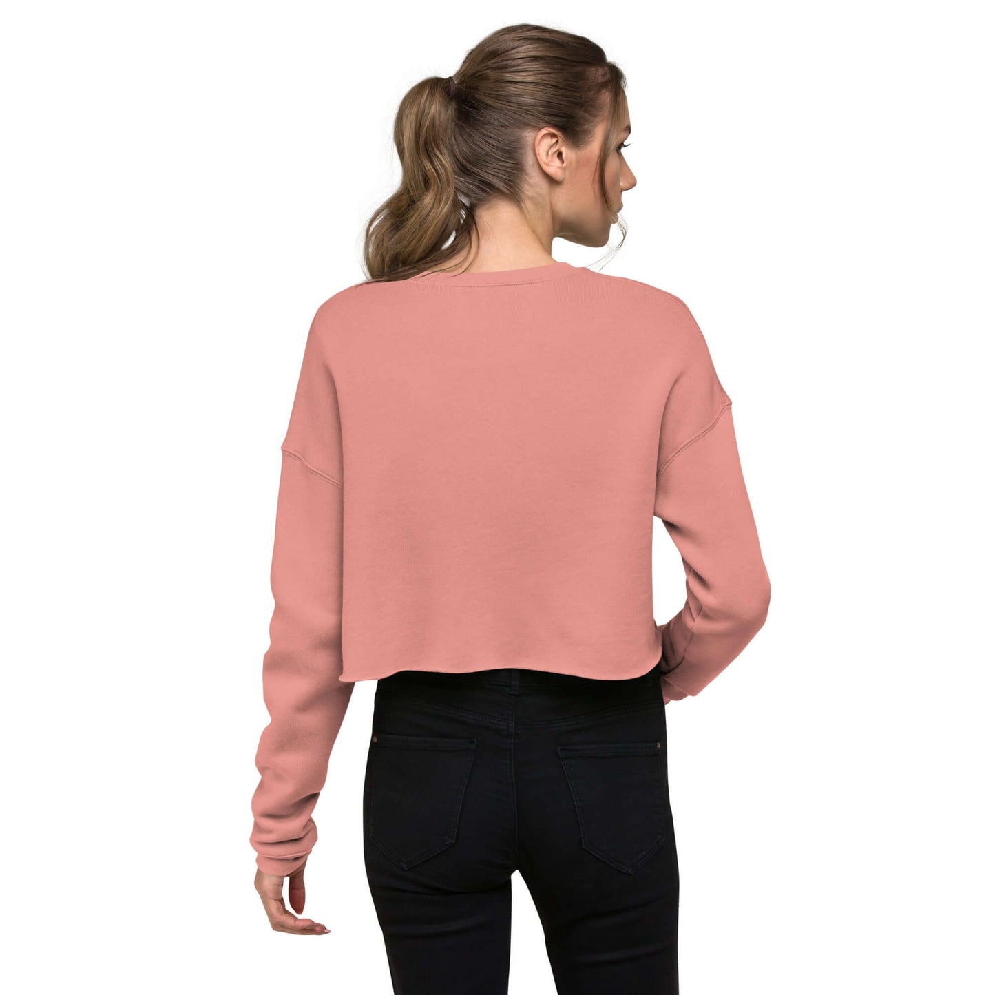 Woman wearing Crop-Pullover N°0 in pink, showing the back design with ribbed neckline and raw hem, combining fashion and comfort.