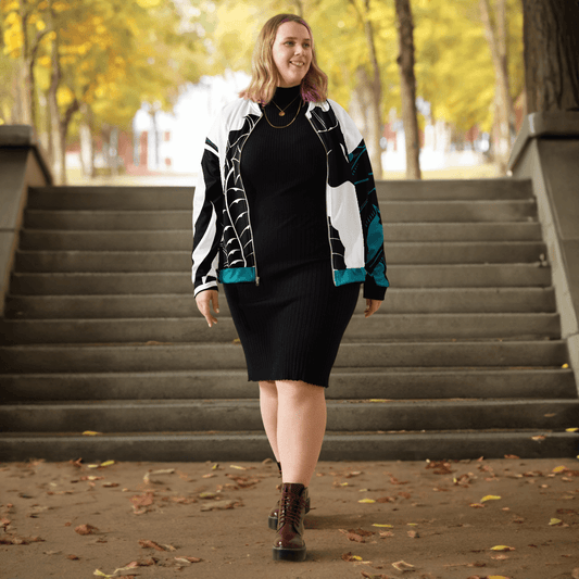 Smiling woman in stylish dress and jacket walking down outdoor stairs in autumn setting.