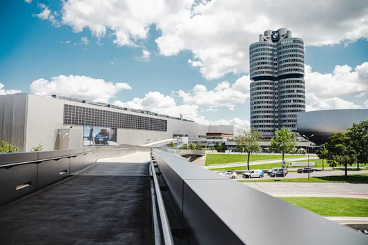 View of the BMW headquarters and museum under a blue sky with clouds.