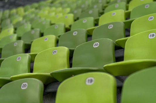 Rows of empty green stadium seats numbered from 19 to 21, showcasing a vibrant seating arrangement.