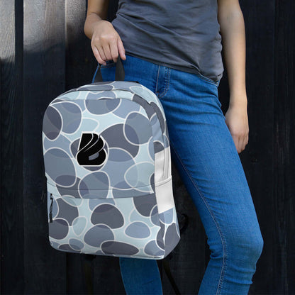 Person holding Rucksack N°5, the perfect waterproof polyester backpack for daily use with laptop pocket, in stylish pattern design.